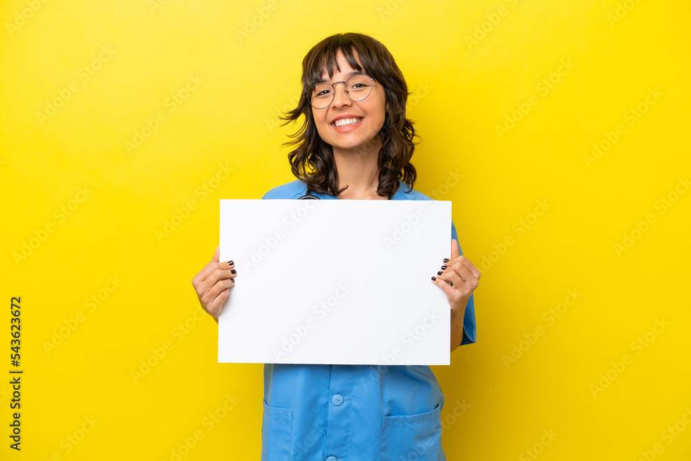 Young nurse doctor woman isolated on yellow background holding an empty placard with happy expression Young nurse doctor woman isolated on yellow background holding an empty placard with happy expression