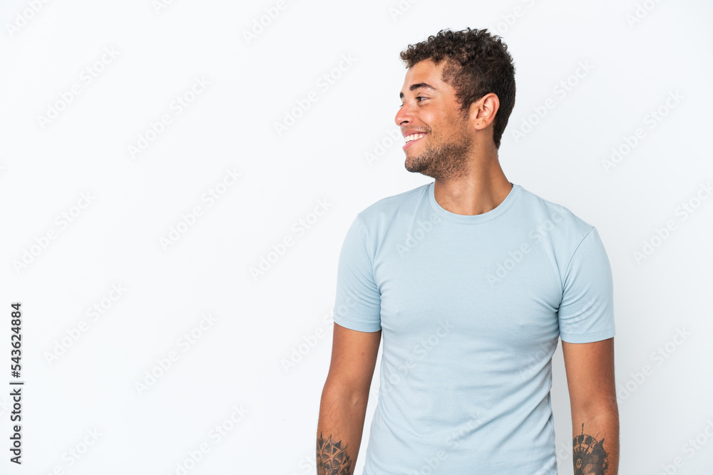 Young handsome Brazilian man isolated on white background looking side Young handsome Brazilian man isolated on white background looking side
