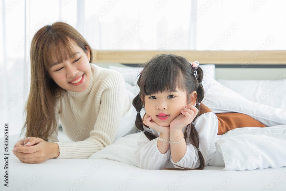 Happy loving family. Asian mother and her daughter child girl playing in bedroom. Happy loving family. Asian mother and her daughter child girl playing in bedroom.
