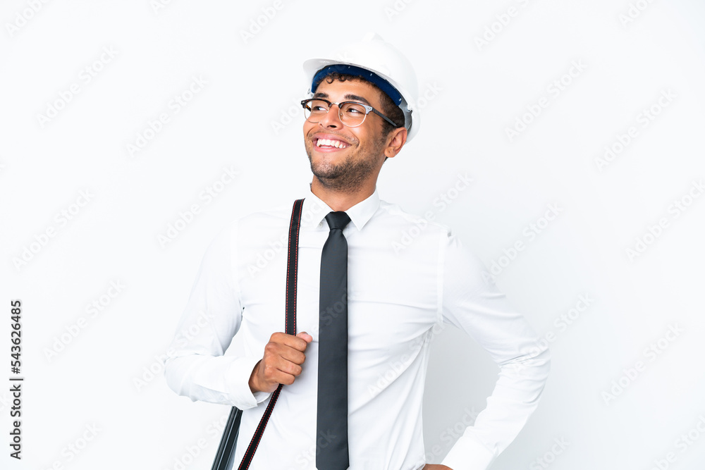 Architect brazilian man with helmet and holding blueprints posing with arms at hip and smiling Architect brazilian man with helmet and holding blueprints posing with arms at hip and smiling