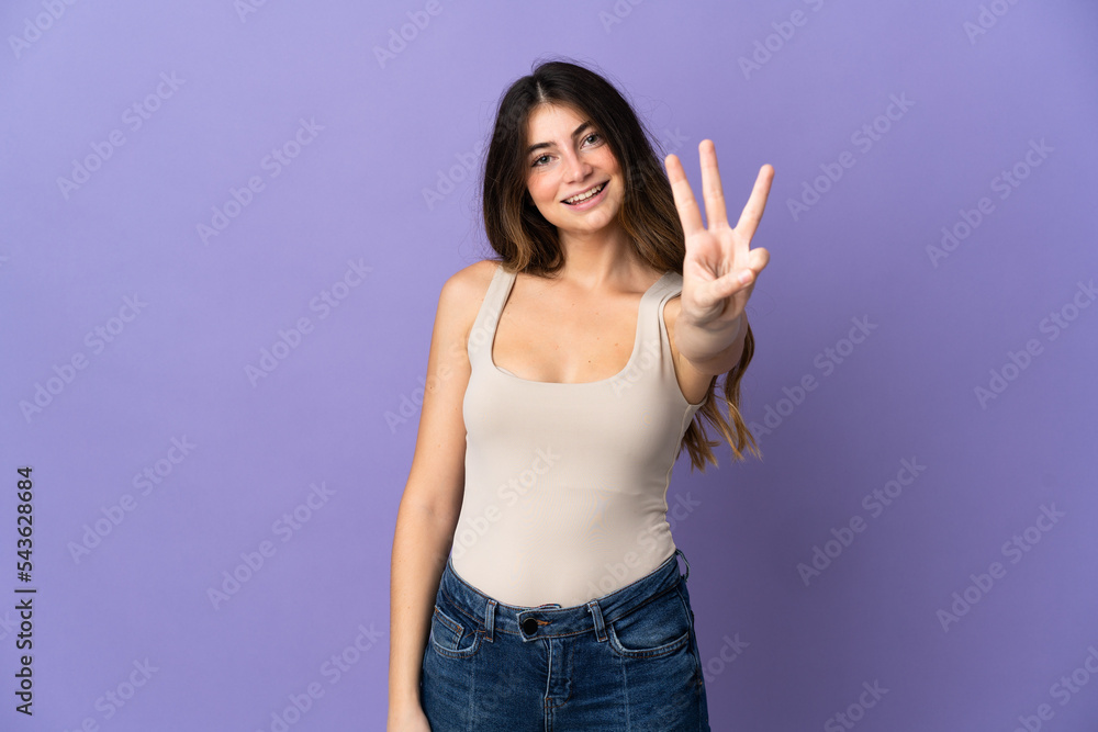 Young caucasian woman isolated on purple background happy and counting three with fingers Young caucasian woman isolated on purple background happy and counting three with fingers
