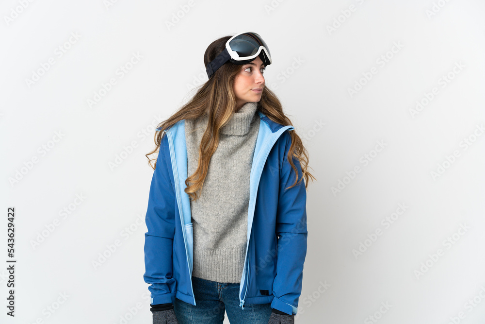 Skier girl with snowboarding glasses isolated on white background looking to the side Skier girl with snowboarding glasses isolated on white background looking to the side