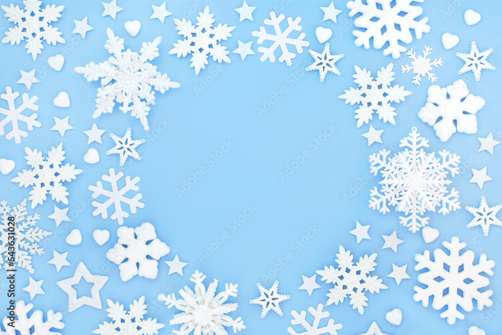 Christmas snowflake heart and star shape tree decorations. Festive background border design on pastel blue. Fantasy symbols for winter, Xmas and New Year holiday Season.