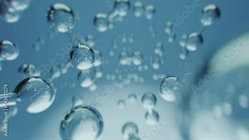 Multiple shiny hydrogen or oxygen gas particles floating slowly in the air. Photorealistic science, medical background 3D animation.