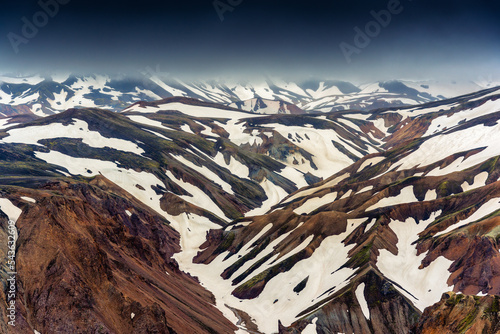 Scenery of volcanic mountain and snow covered in Blahnjukur trail on Icelandic highlands at Landmannalaugar photo