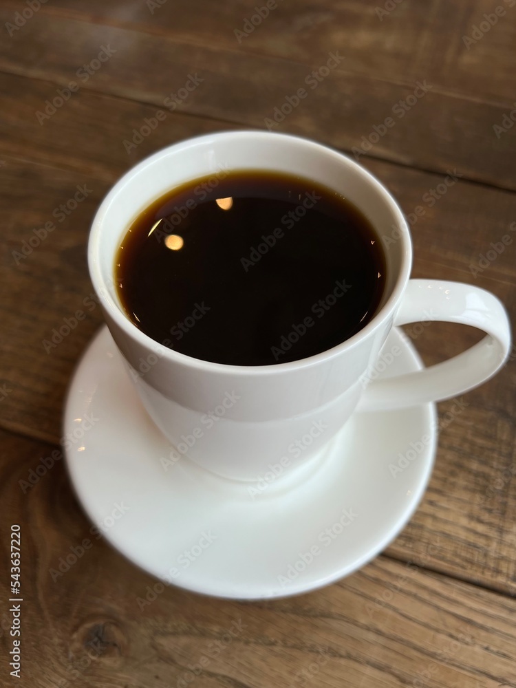 Fototapeta premium White cup of coffee on wooden table