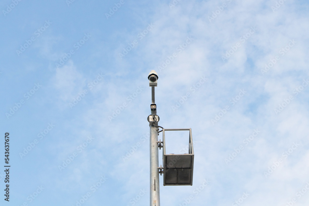 Closed-circuit CCTV, camera big size on pole in circle white blue sky background in sunlight. Tough cameras can record events such as traffic, accidents. prevent thief. Maintain safety important area Closed-circuit CCTV, camera big size on pole in circle white blue sky background in sunlight. Tough cameras can record events such as traffic, accidents. prevent thief. Maintain safety important area