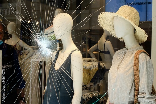 Broken glass of store window at Ermou street, in the commercial center of Athens, after vandalism made by anarchists - Athens,  Greece, June 28 2020. photo