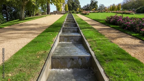 stepped water feature in designer garden with topiary hedges and flower borders, Chateau des Milandes, former home of Josephine Baker, Dordogne France photo