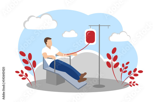 A man sits in a chair and donates blood. Blood donor.