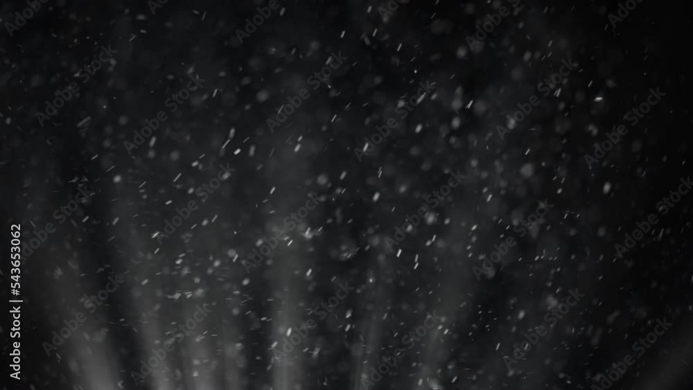 Large snowflakes are spinning in the wind under the light of a lantern Large snowflakes are spinning in the wind under the light of a lantern