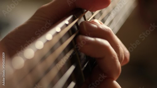 Acoustic guitar solo fingers on fretboard macro, guitar player playing music