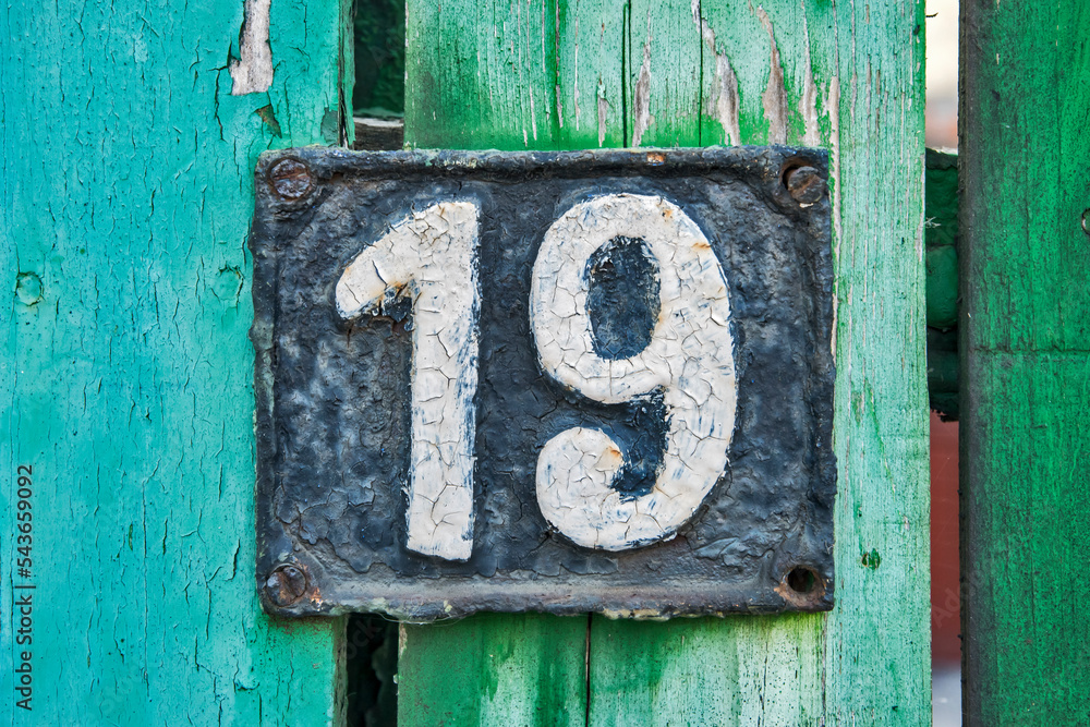 Old retro weathered cast iron plate with number 19 closeup Old retro weathered cast iron plate with number 19 closeup