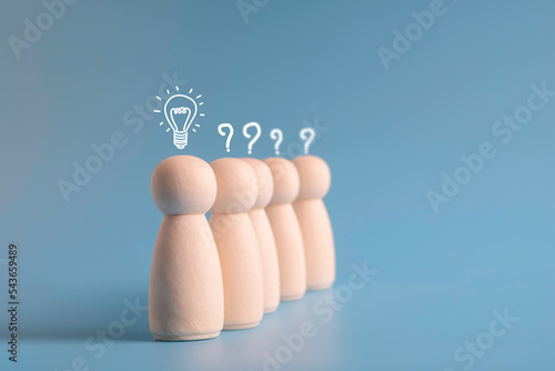 Wooden humans or leaders business new ideas with light bulb and other humans with question marks for creative thinking and problem solving solution concept