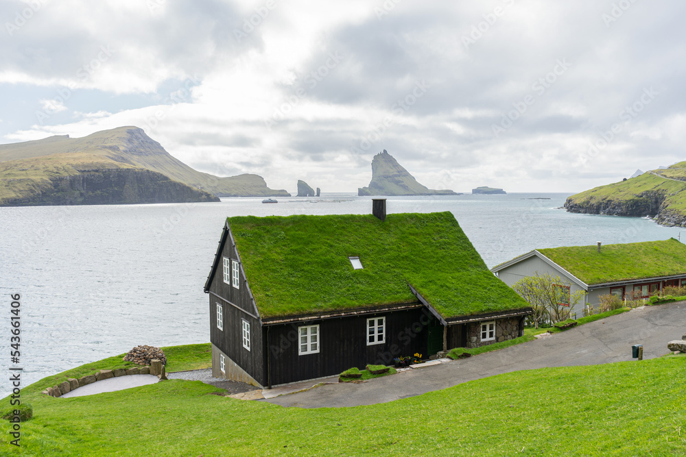 Road near the beautiful mountains, and the sea bay. Faroe Islands.Denmark, Europe. Landscapes. Nature. Traveling concept Road near the beautiful mountains, and the sea bay. Faroe Islands.Denmark, Europe. Landscapes. Nature. Traveling concept