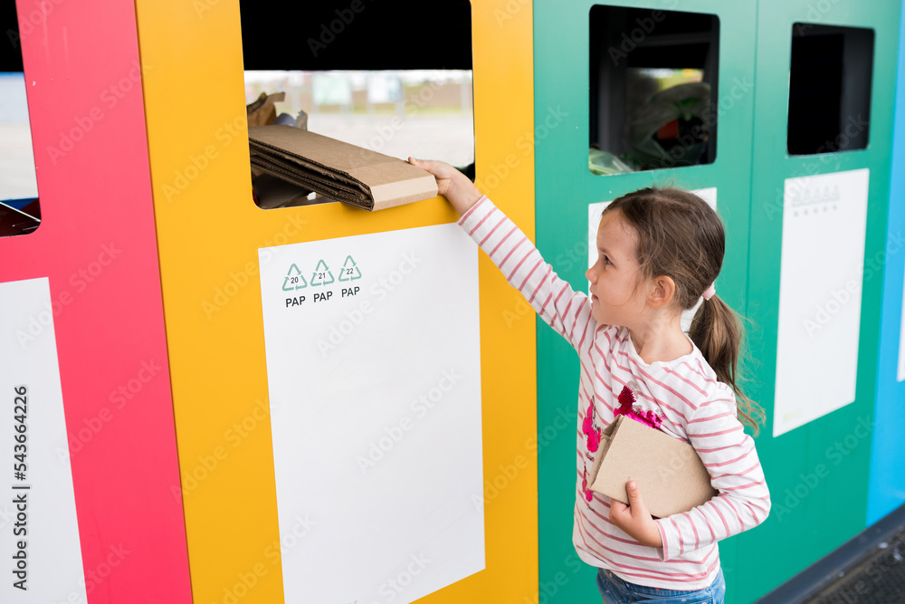 Girl dumping cardboard in bank for reduce, reuse, recycle. National