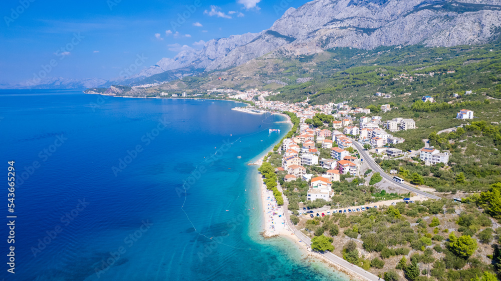 Beautiful azure blue Mediterranean beach surrounded by green trees in Croatia