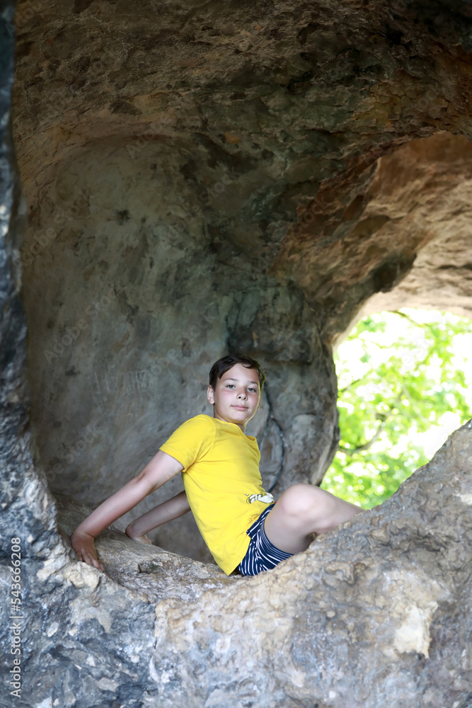 Boy posing in cave of Una-Koz ridge