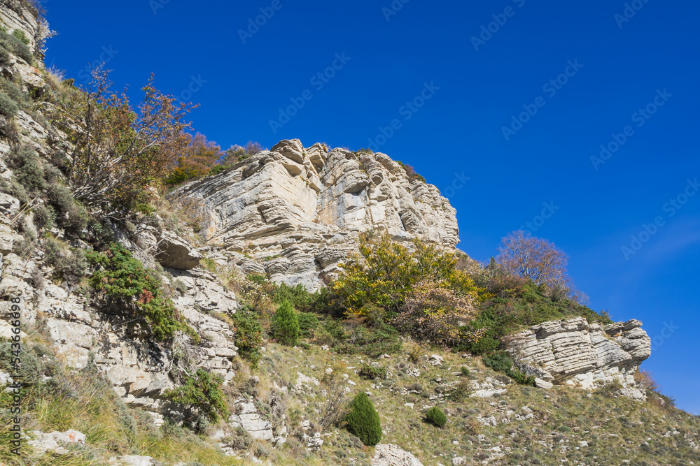 Autumn landscape in Les Trois Becs in Drôme provençale. The top limestone rocks is covered with green grass