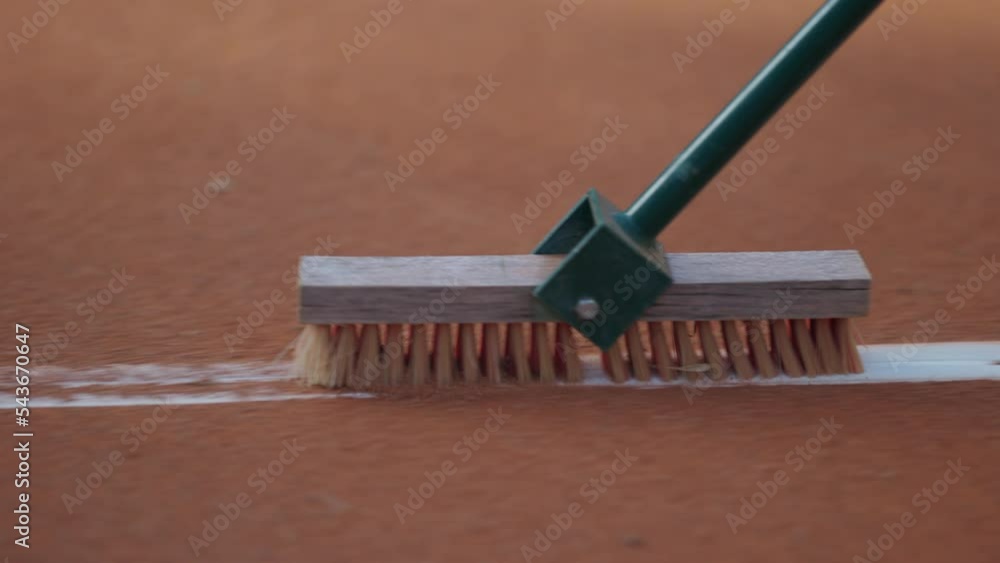 Cleaning marking line clay tennis court with brush Clay tennis court Cleaning marking line clay tennis court with brush Clay tennis court