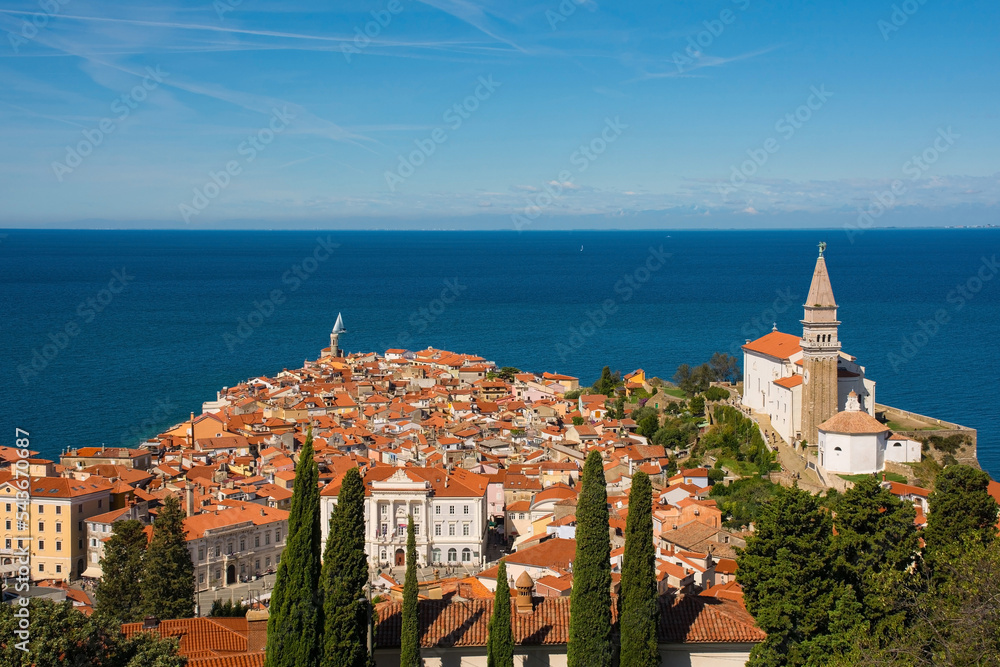 Fototapeta premium The old medieval centre of Piran on the coast of Slovenia. The large church is St George's Parish Church 