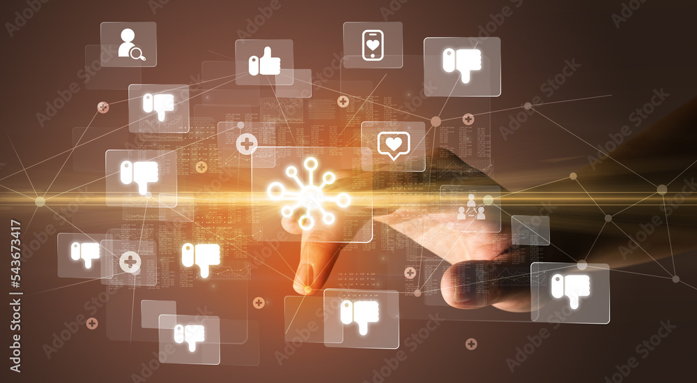 Hand pressing social media multimedia application screen with media icons on futuristic concept Hand pressing social media multimedia application screen with media icons on futuristic concept