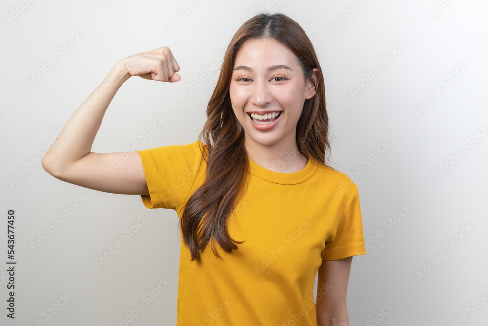 Smiling positive, cute asian young woman, girl wearing yellow casual, portrait of beautiful brunette with long hair, feeling fighting, cheering, looking at camera standing isolated on white background Smiling positive, cute asian young woman, girl wearing yellow casual, portrait of beautiful brunette with long hair, feeling fighting, cheering, looking at camera standing isolated on white background