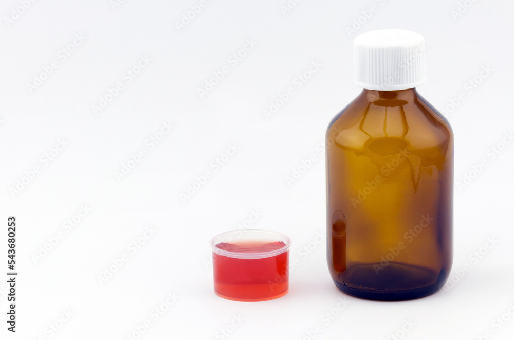 Healthcare and medical concept. Cough syrup glass bottle with dosage