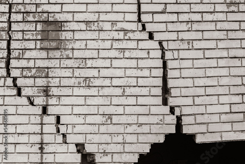 Building Exterior Wall Cracked Damaged Closeup abstract background sepia black and white photograph. photo