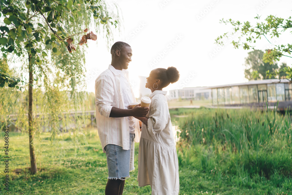 Black couple holding hands and standing together in park Stock Photo ...