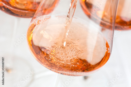 Pouring rose wine in a glass