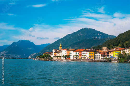 Panoramic view of the ancient lakeside village of Brusino Arsizio, located at the foot of Monte San Giorgio, on the shores of Lake Lugano, Ticino, Switzerland. 