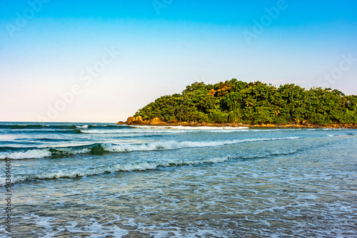 Peaceful and idyllic beach with the rainforest and the sea in Bertioga on the nort coast of the state of Sao Paulo, Brazil photo