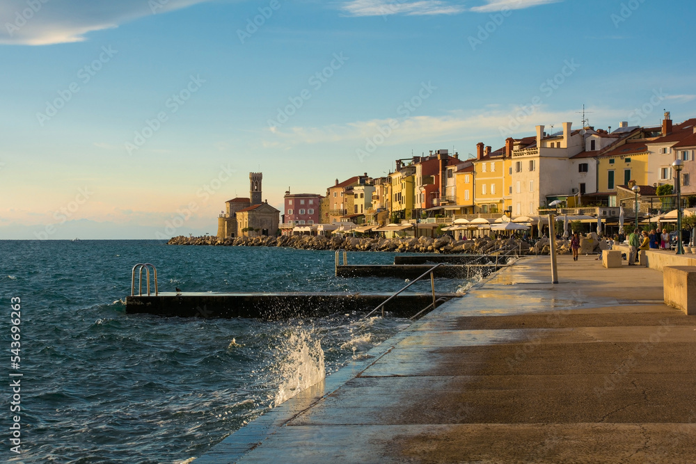 The waterfront of the historic medieval town of Piran on the coast of Slovenia. Background centre is the Our Lady of Health Church and a 17th century lighthouse tower
