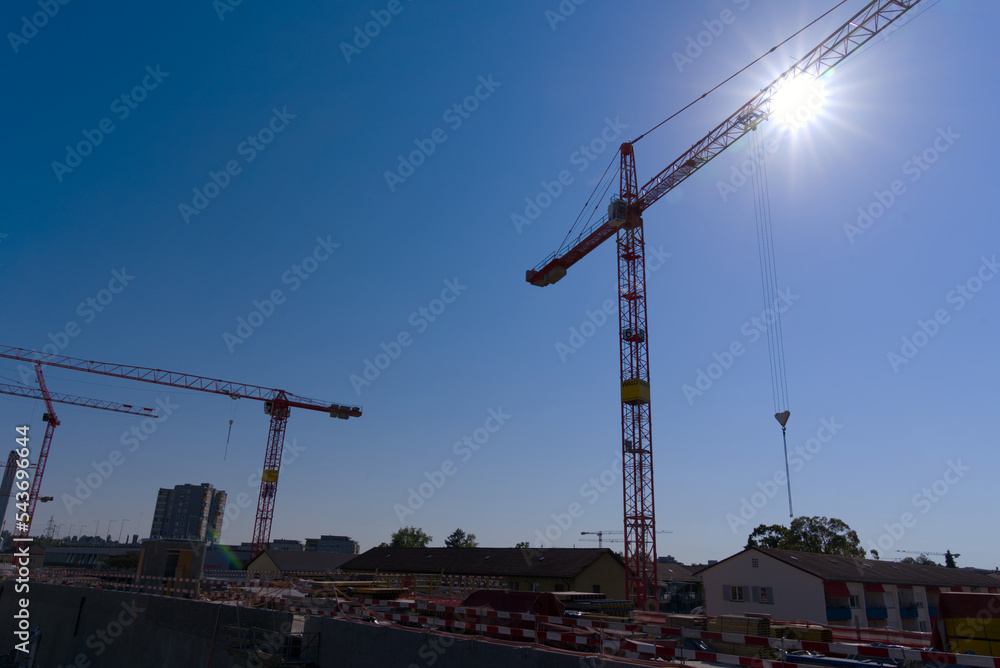 Aerial view of highway enclosure construction site with cranes and backlight at City of Zürich on a sunny summer day. Photo taken August 16th, 2022, Zurich, Switzerland.