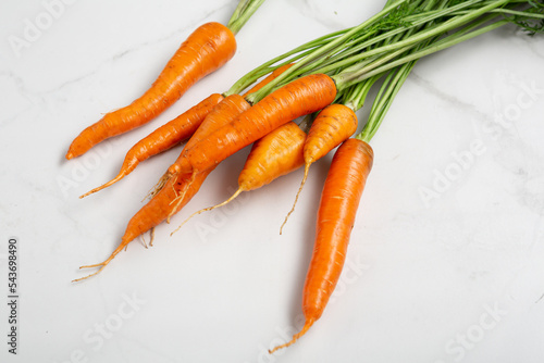 Bunch of fresh carrots fresh vegetables on marble surface food