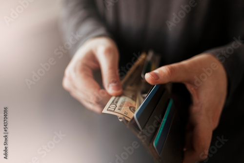 man takes money out of wallet