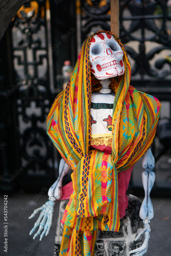 multicolored day of the dead skulls, day of the dead with bones and figures of paper and traditional mexican clay