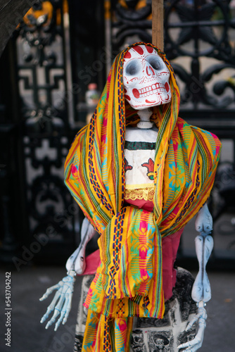 multicolored day of the dead skulls, day of the dead with bones and figures of paper and traditional mexican clay