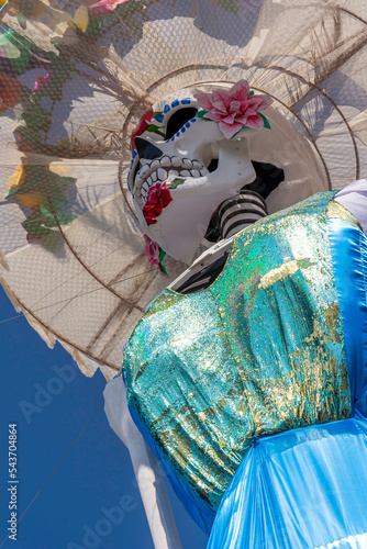 Huge skull and crossbones with regional Mexican dress for traditional Day of the Dead festivities called Catrina