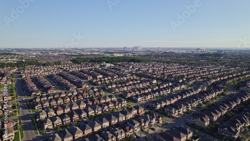 Aerial view of American suburban neighbourhood. Residential single American family houses. North America suburb streets. Established Real estate at golden hour sunset with long shadows.