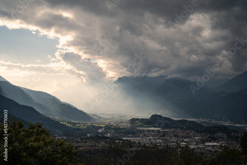 Light rays shine on the Camonica Valley after a storm, Northern Italy