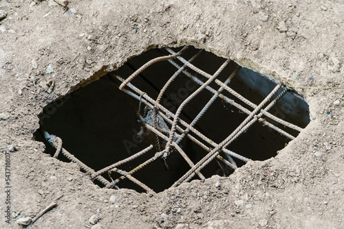 Large dark hole in concrete floor