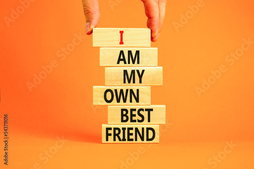 I am my own best friend symbol. Concept words I am my own best friend on wooden blocks on a beautiful orange table orange background. Businessman hand. Business i am my own best friend concept.