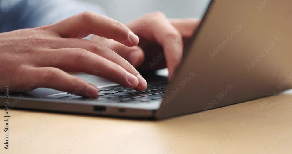 Close up hands of man typing on laptop keyboard sitting at workplace Close up hands of man typing on laptop keyboard sitting at workplace