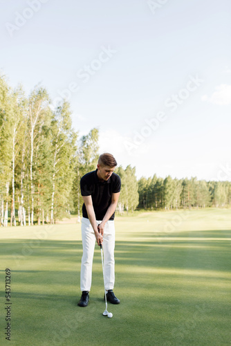 A man golfer plays on the field. Time for golf. High quality photo