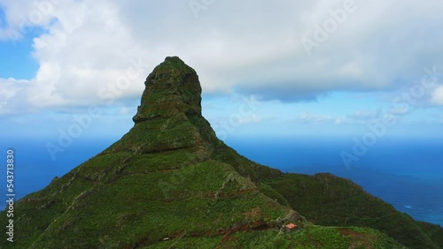 Roque de Taborno. Geological formations within the Macizo de Anaga mountain range. Biosphere Reserve on Tenerife Canary Islands Spain. Clouds on sky. Deep blue ocean water. Peaceful background. photo