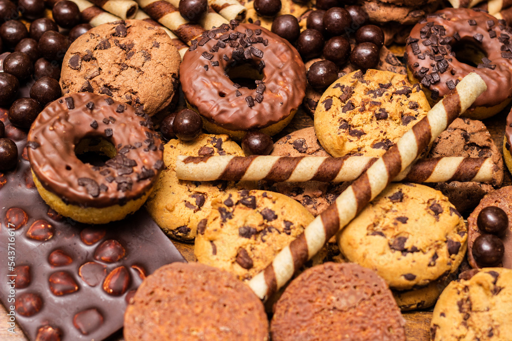 Beautiful chocolate, doughnuts, chocolate stick, and chocolate chip cookies background Beautiful chocolate, doughnuts, chocolate stick, and chocolate chip cookies background