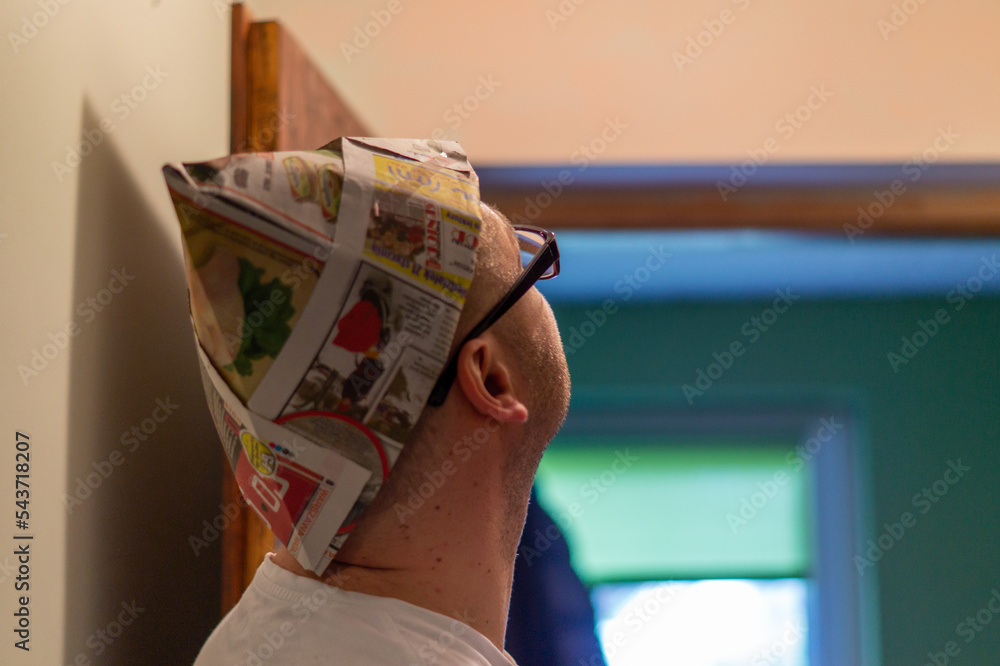 Obraz na płótnie Mężczyzna patrzący w górę przygotowuje się do malowania pomieszczenia. Czapka z gazety chroniąca głowę przed farbą. w salonie