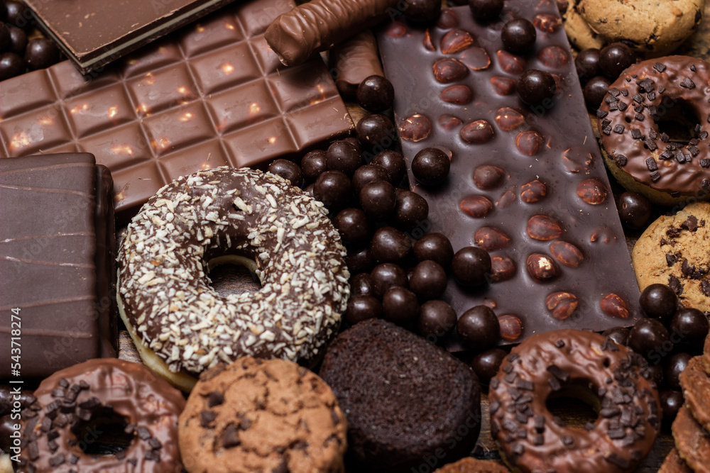 Beautiful chocolate, doughnuts, chocolate stick, and chocolate chip cookies background Beautiful chocolate, doughnuts, chocolate stick, and chocolate chip cookies background